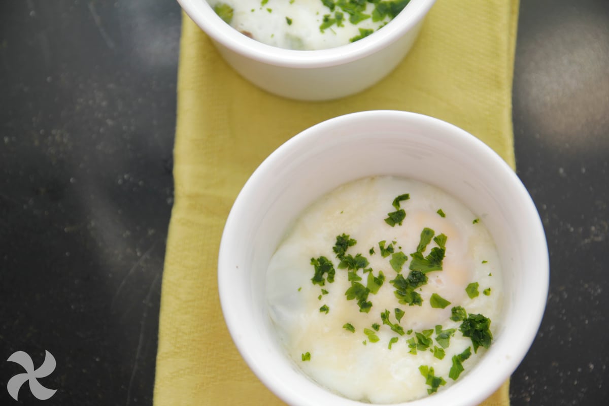 Huevos en cocotte con jamón y guisantes