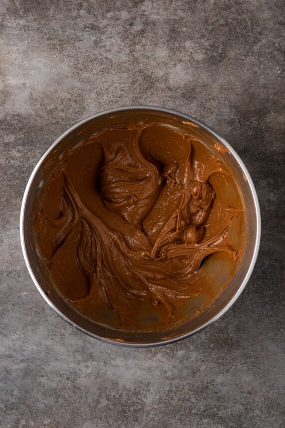 Los brownies caseros de Nutella son ricos, dulces y se arremolinan con crema de chocolate y avellanas. ¡Prepáralos en un tazón con solo 7 ingredientes! Masa de brownie de Nutella en un tazón de metal.
