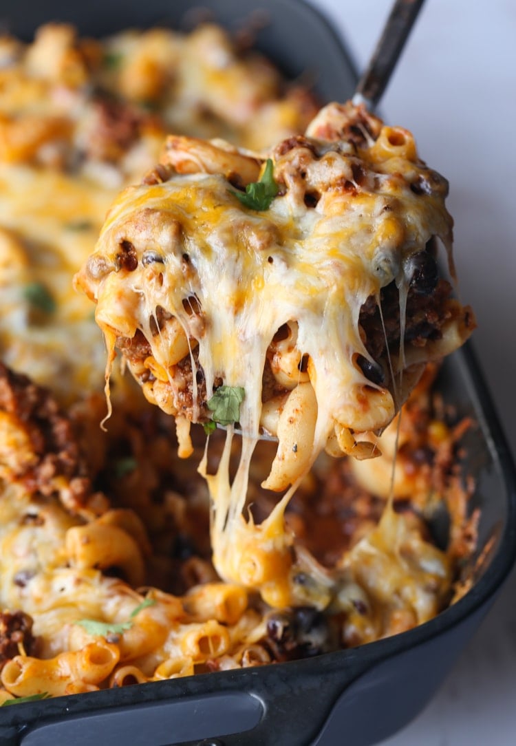 Sirviendo Chili Mac Casserole con tira de queso