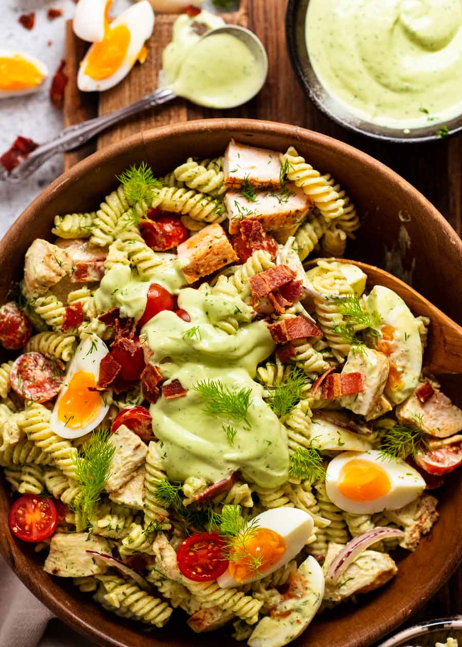 Ensalada de pasta con aderezo ranch de aguacate en una ensaladera lista para servir