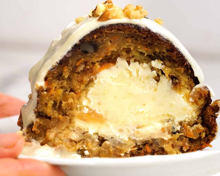 Primer plano de una rebanada de pastel de zanahoria relleno de tarta de queso