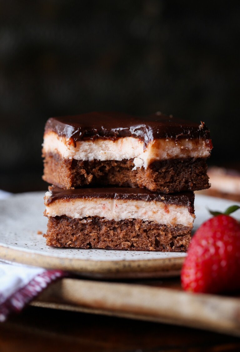 Brownies de fresa apilados en un plato con un bocado sacado