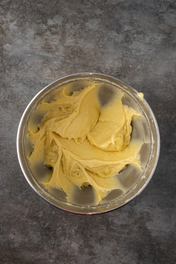 Esta receta de bizcocho Victoria es suave, esponjosa y está hecha con ingredientes simples. ¡Perfecto para combinar con mermelada y crema batida casera! Masa de bizcocho batida en un bol de metal.