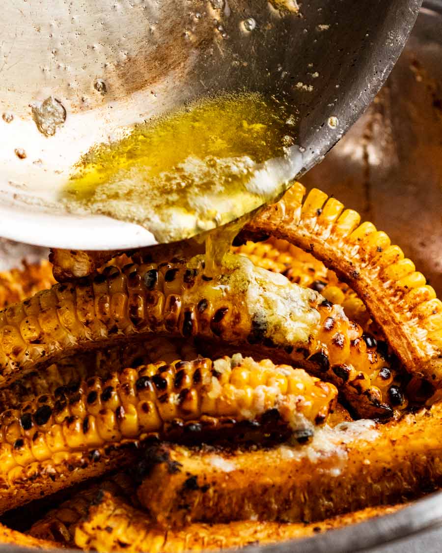 Verter mantequilla de ajo sobre costillas de maíz