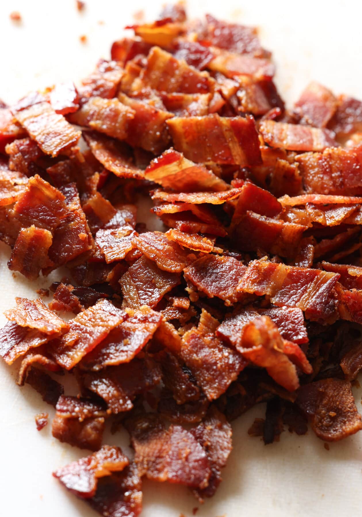 tocino picado en una tabla de cortar blanca