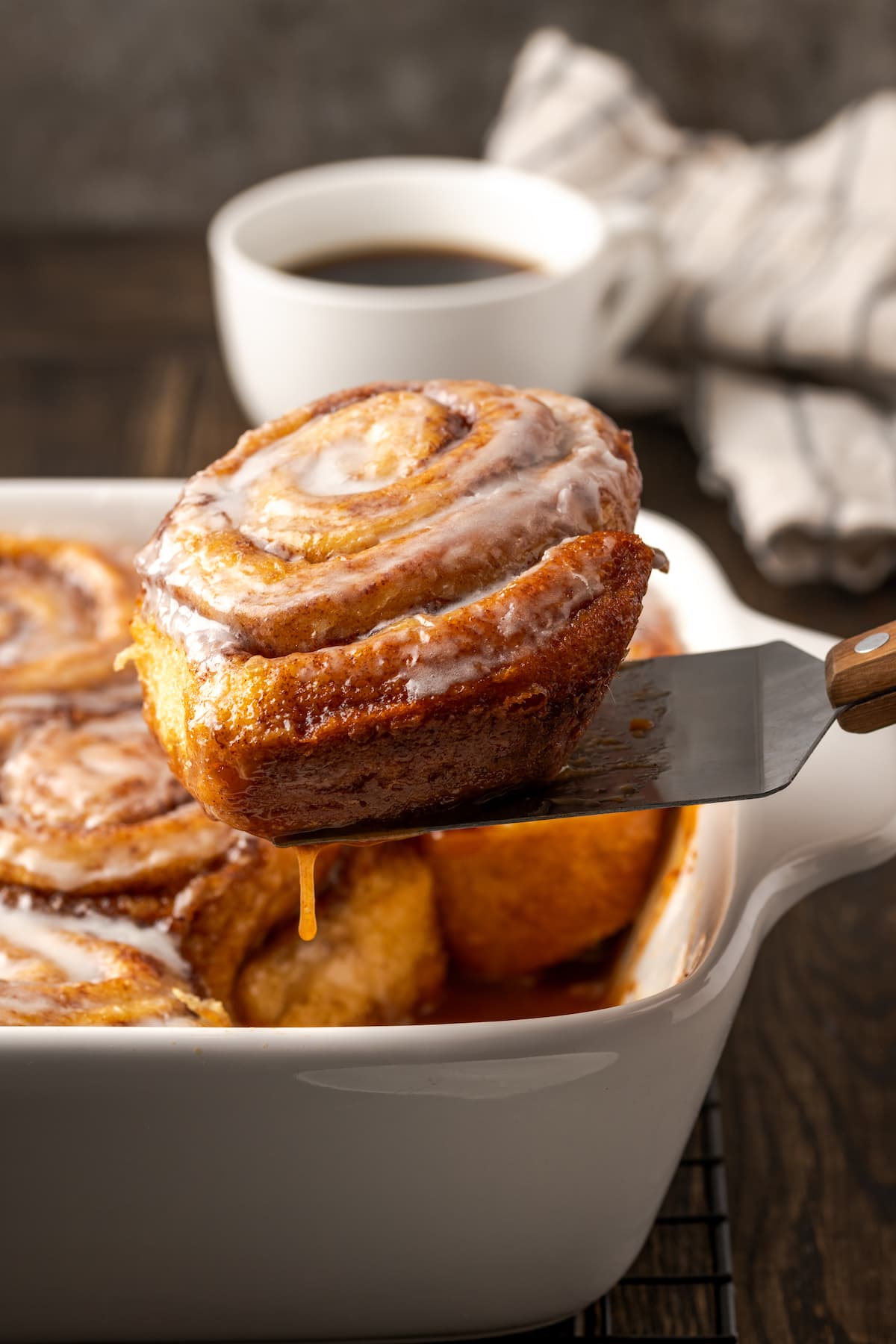 Make the viral TikTok cinnamon rolls with heavy cream! These easy cinnamon rolls taste homemade, perfect as a sweet breakfast or easy dessert. A spatula lifts a TikTok cinnamon roll from a baking dish.