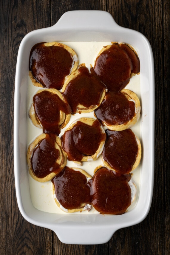 Make the viral TikTok cinnamon rolls with heavy cream! These easy cinnamon rolls taste homemade, perfect as a sweet breakfast or easy dessert. Unbaked Grands cinnamon rolls surrounded by heavy cream and covered with cinnamon sugar sauce in a white ceramic baking dish.