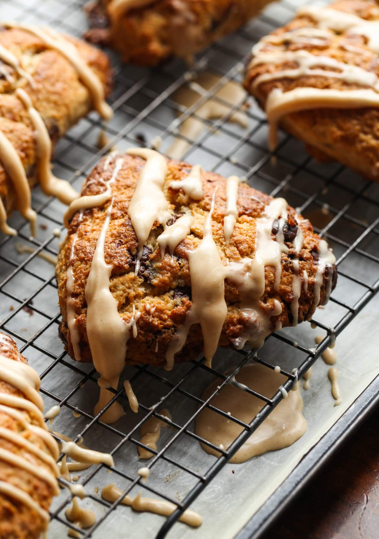 These Chocolate Chip Banana Scones have perfectly crisp, buttery edges with a fluffy, yet flaky, soft center making this the perfect scone recipe! Banana Scone on a cooling rack with icing
