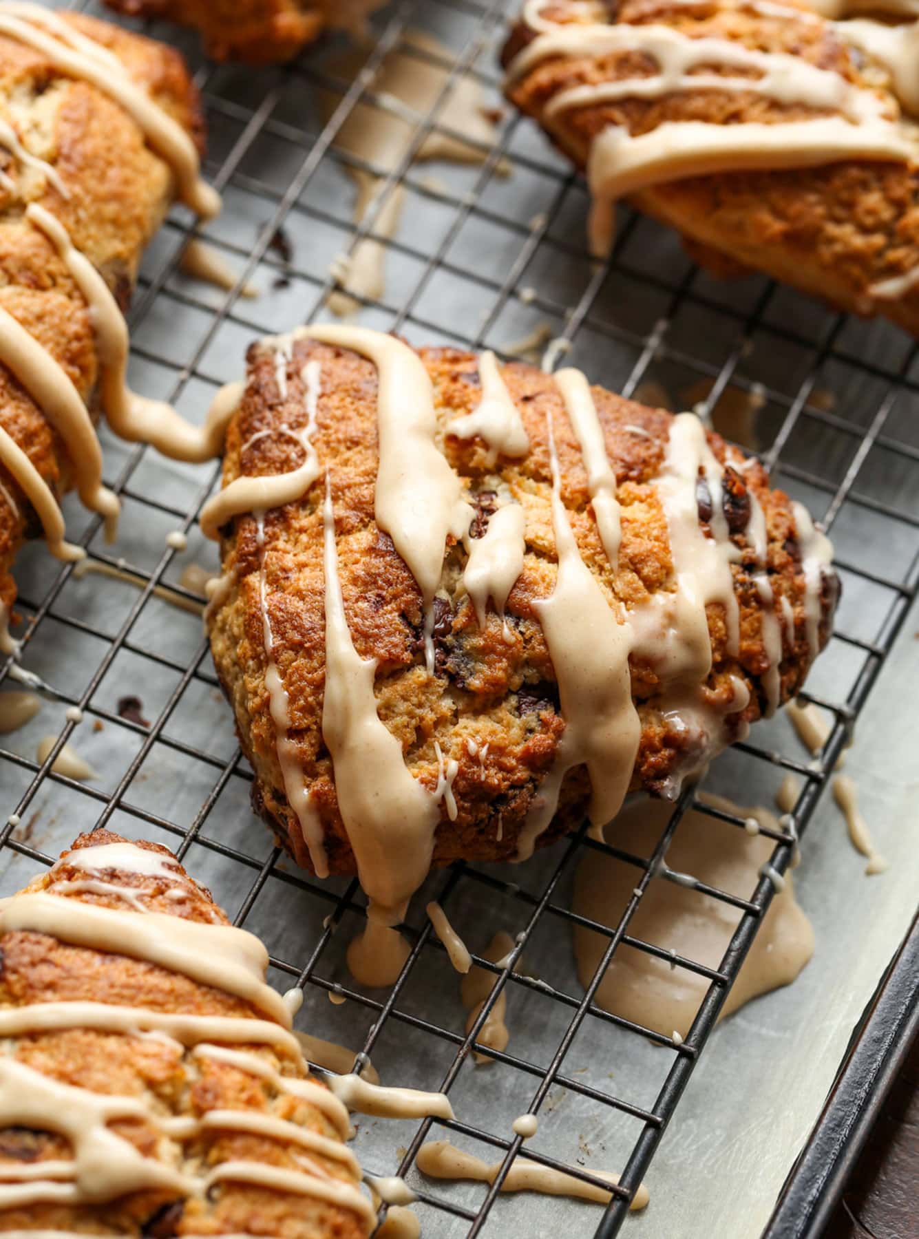 These Chocolate Chip Banana Scones have perfectly crisp, buttery edges with a fluffy, yet flaky, soft center making this the perfect scone recipe! Banana Scone on a cooling rack with icing