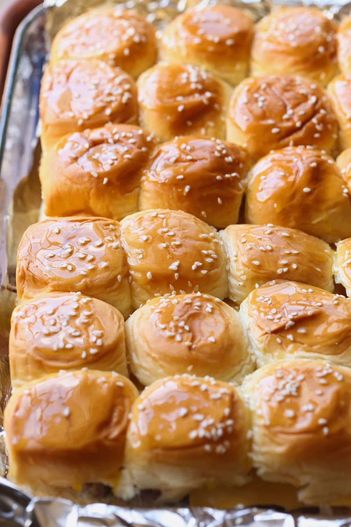 Burgers garnished with butter and sesame seeds. 