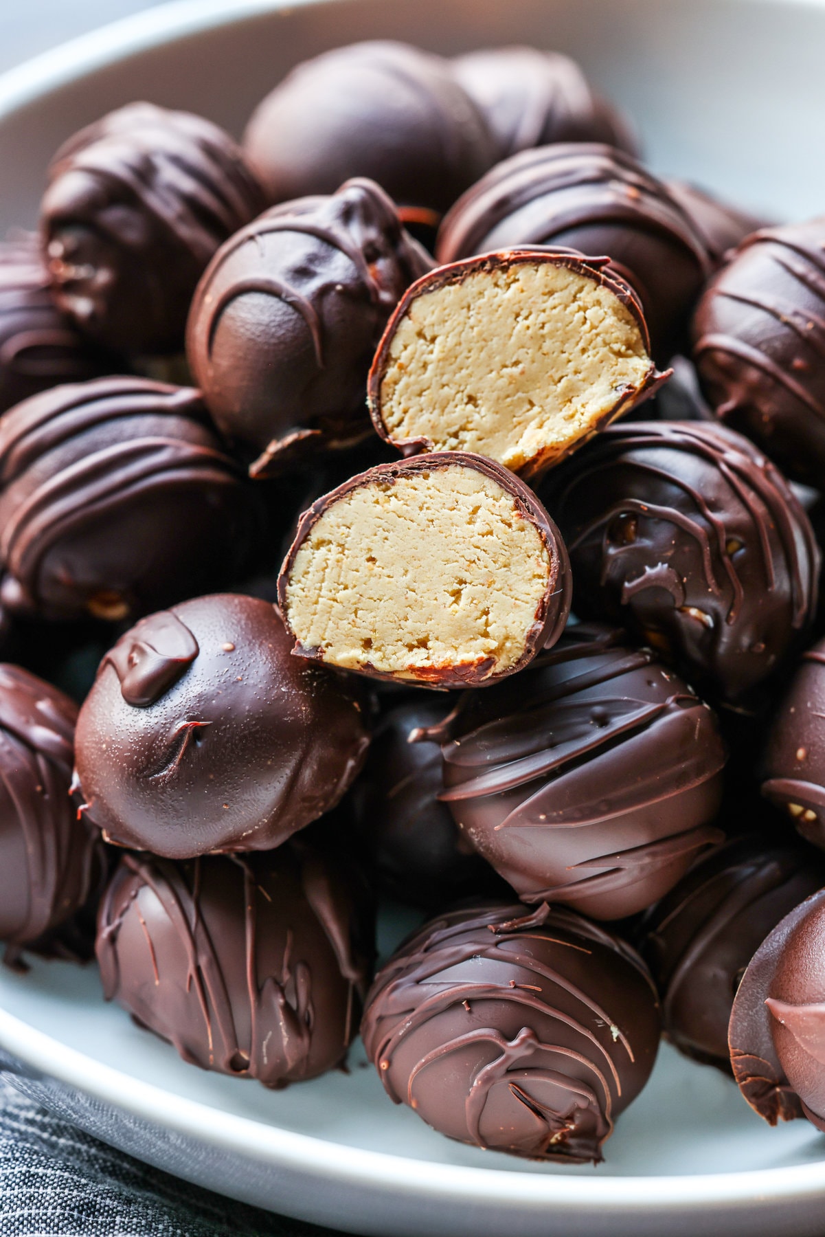 A peanut butter ball cut in half showing the inside.