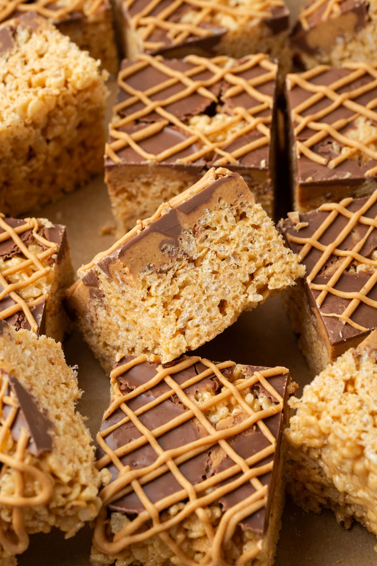 Overhead view of assorted peanut butter rice krispie treats drizzled with melted peanut butter chips.