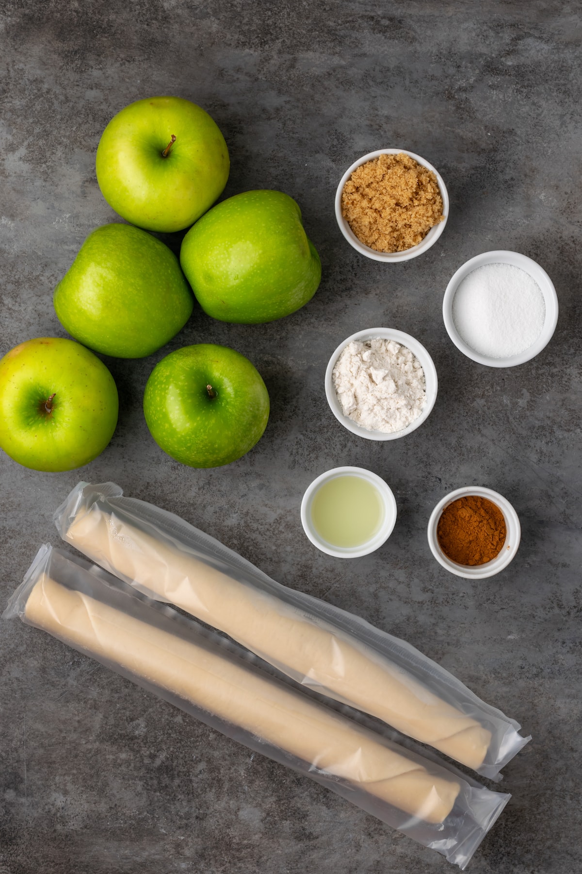 Mini apple pies are a bite-sized spin on a classic fall dessert! So easy to make and bursting with juicy apple pie filling and warm spices. The ingredients for mini apple pies.