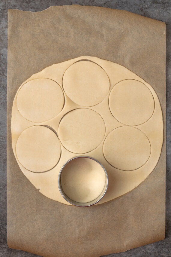 Mini apple pies are a bite-sized spin on a classic fall dessert! So easy to make and bursting with juicy apple pie filling and warm spices. A cookie cutter is used to cut out circles from a rolled out pie crust.
