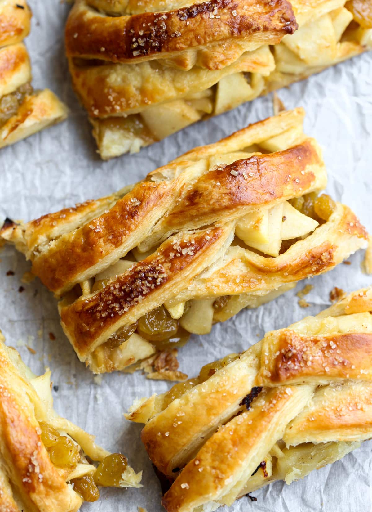 This easy Apple Strudel is filled with cinnamon, brown sugar, raisins and more! It's a crispy, flaky pastry that's easy to make and downright delicious. Slices of apple strudel with golden brown pastry