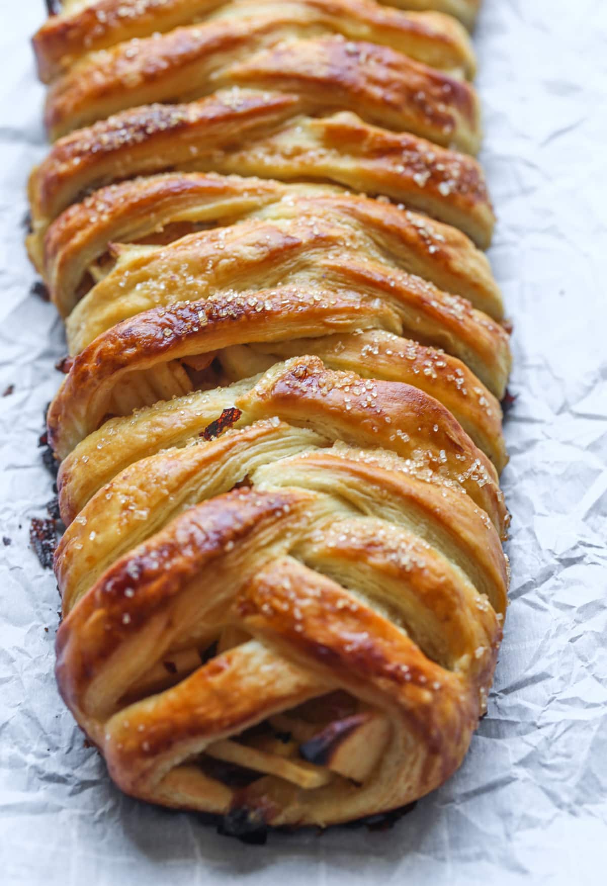 This easy Apple Strudel is filled with cinnamon, brown sugar, raisins and more! It's a crispy, flaky pastry that's easy to make and downright delicious. Golden brown Apple Strudel right out of the oven on a baking sheet