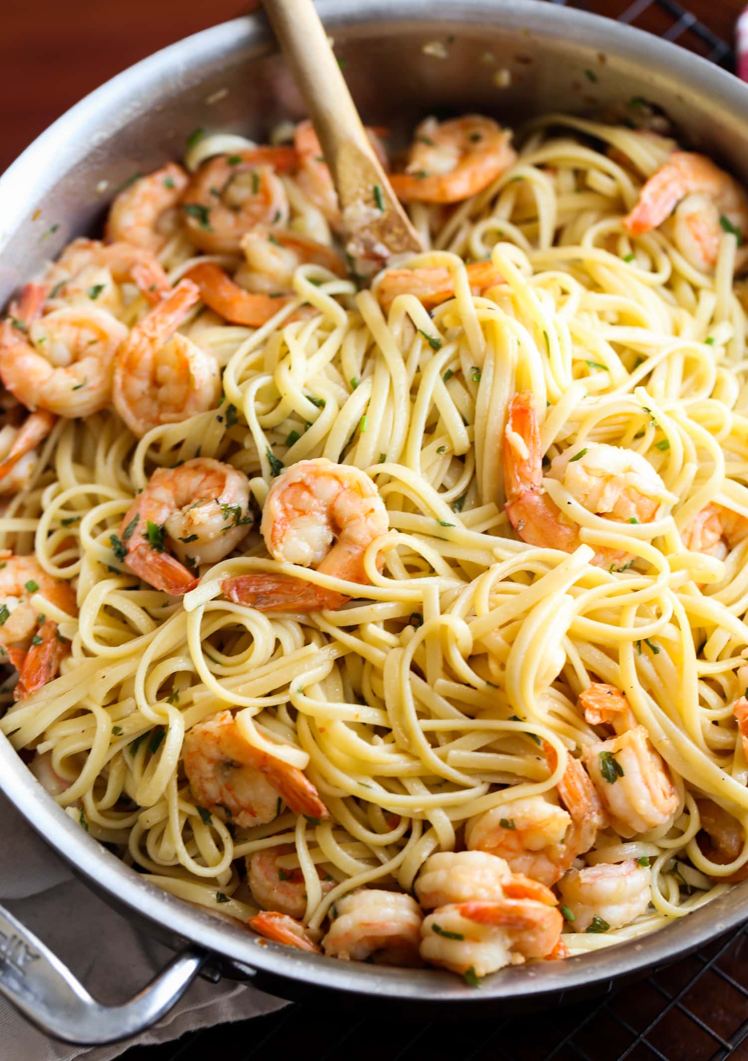 This classic shrimp scampi recipe is INSANELY delicious! Buttery, garlicky sauce with perfectly cooked shrimp and linguine pasta. So good! Shrimp scampi in a pan with linguine.