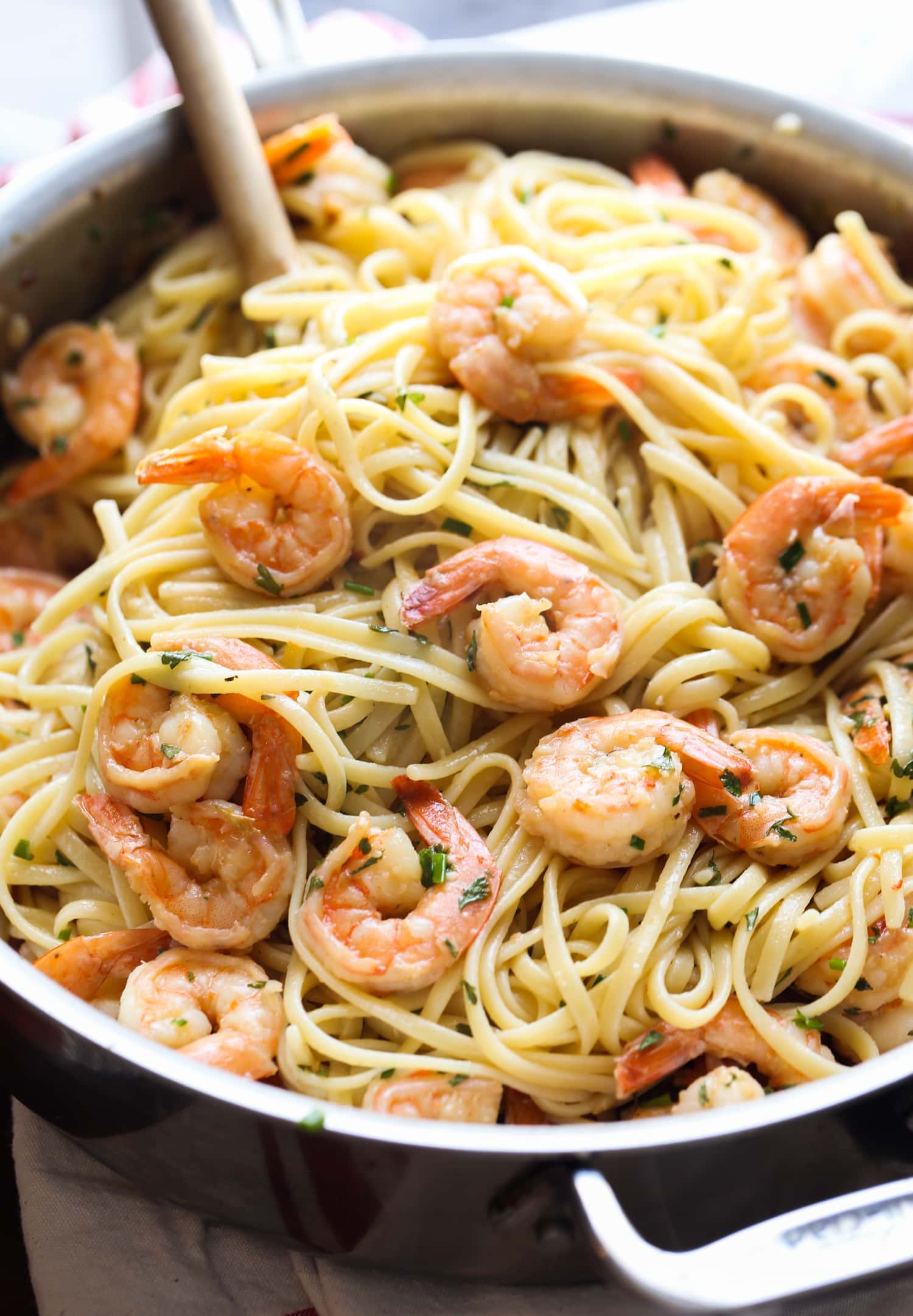 This classic shrimp scampi recipe is INSANELY delicious! Buttery, garlicky sauce with perfectly cooked shrimp and linguine pasta. So good! Pan full of shrimp and linguine.