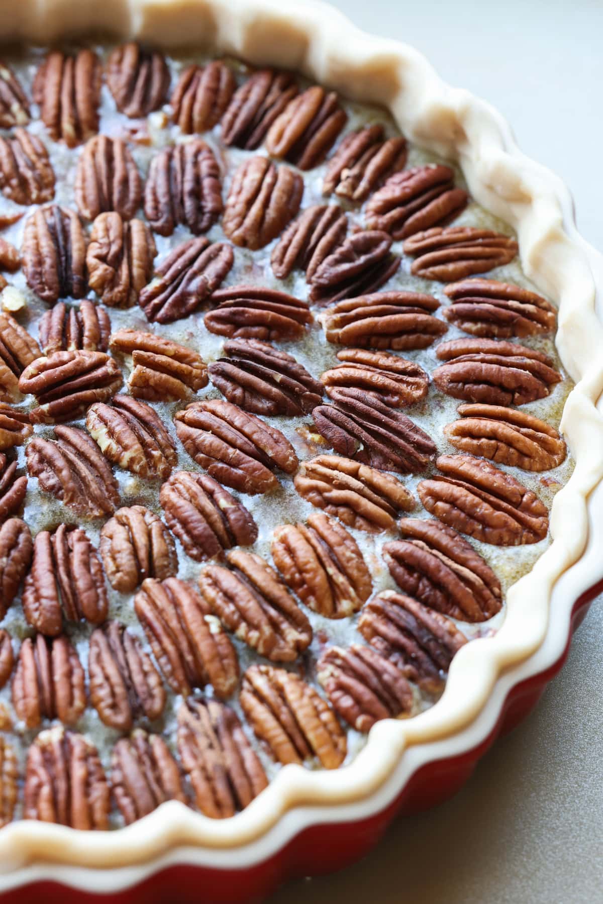 pecan halves on a pecan tart before being baked
