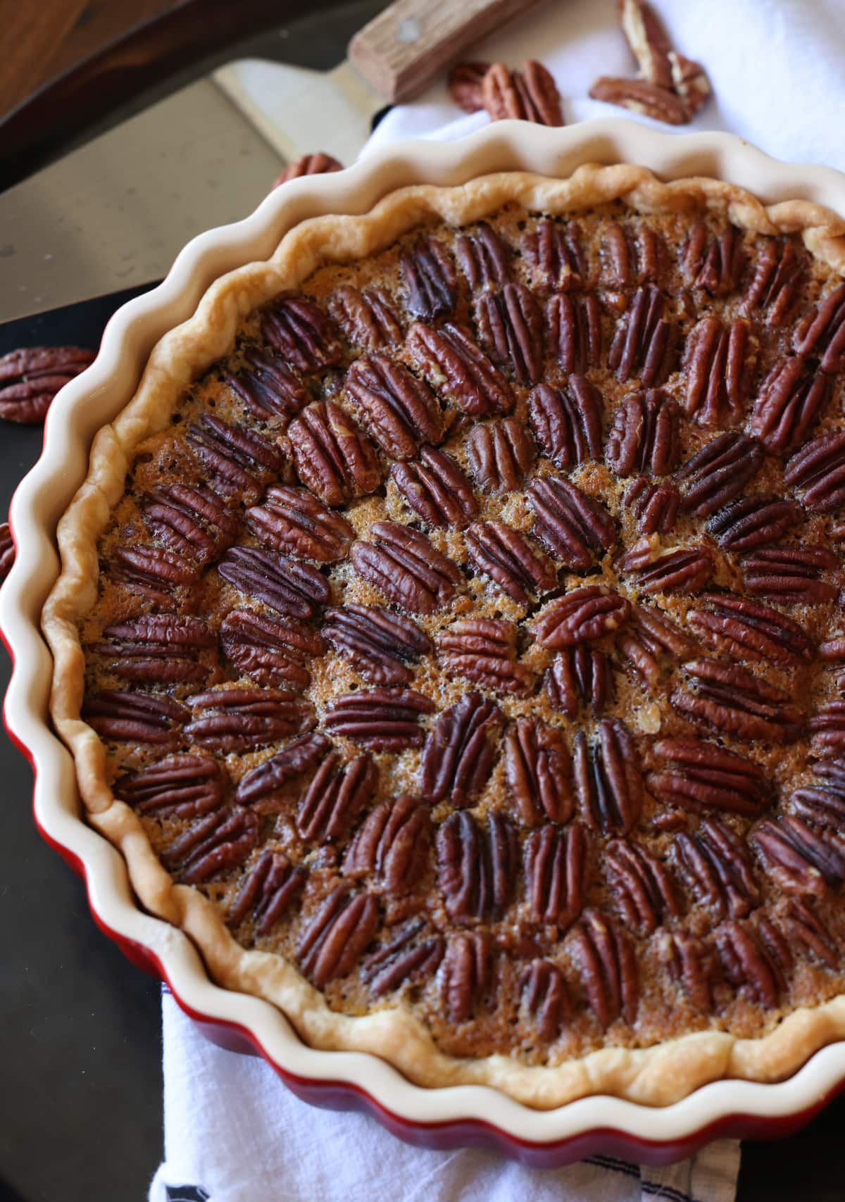 A pecan tart baked in a red le creuset baking pan