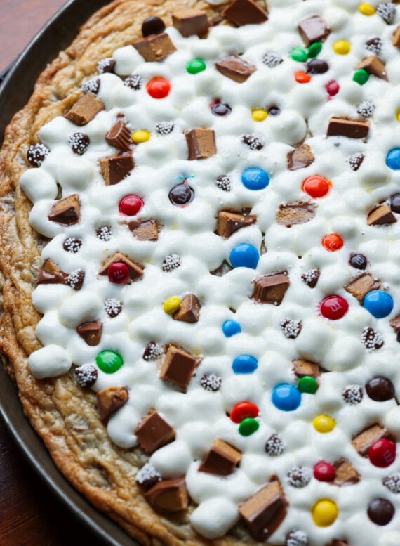 A large cookie pizza baked on a nonstick pizza pan with melted marshmallows for "cheese" and candy toppings