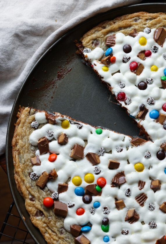 A cookie pizza from abovee with a slice missing