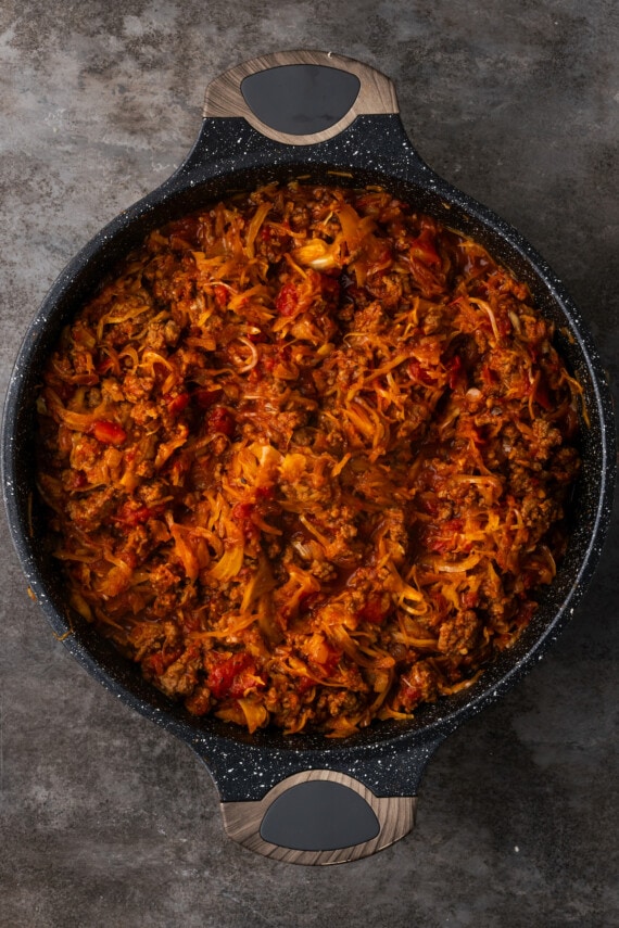 This easy unstuffed cabbage recipe is a savory one-pot meal made with juicy ground beef, pork, tangy fire-roasted tomatoes, and onions. Unstuffed cabbage in a skillet.