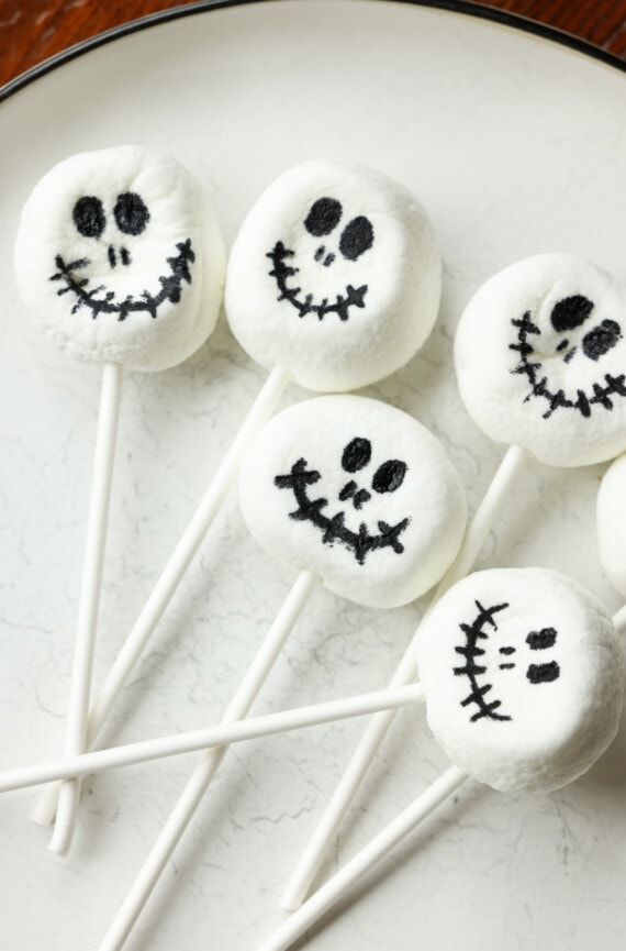 Marshmallows on a lollipop stick with black skeleton faces drawn on