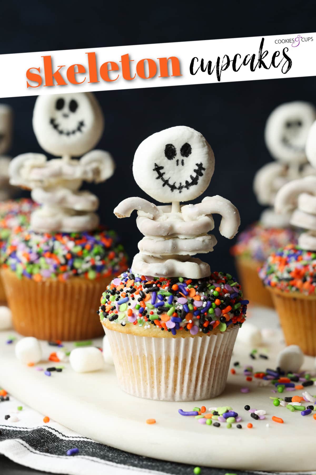 These are adorable Skeleton Halloween Cupcakes that are perfect for spooky season! Easy to make and so cute for classroom parties and a fun activity to do with your kids! Halloween Skeleton Cupcakes Pinterest Image with writing