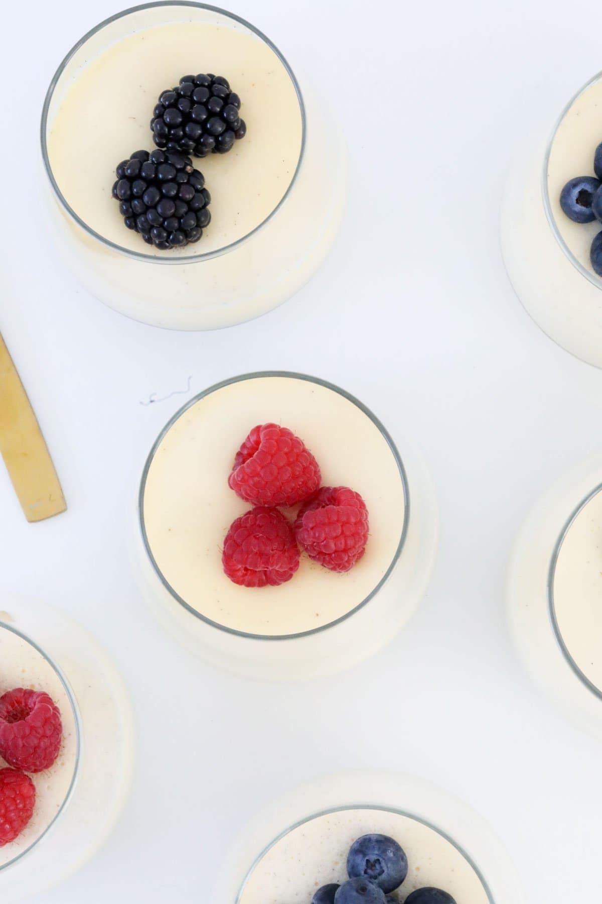 An overhead shot of panna cotta with berries.
