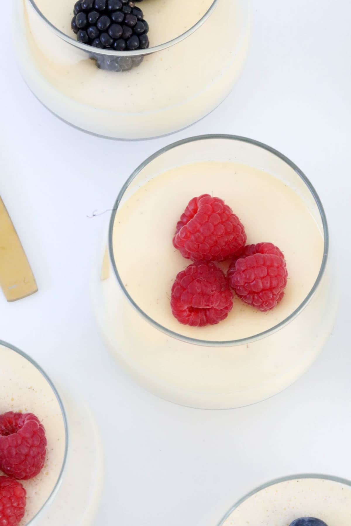 Raspberries on top of homemade panna cotta.