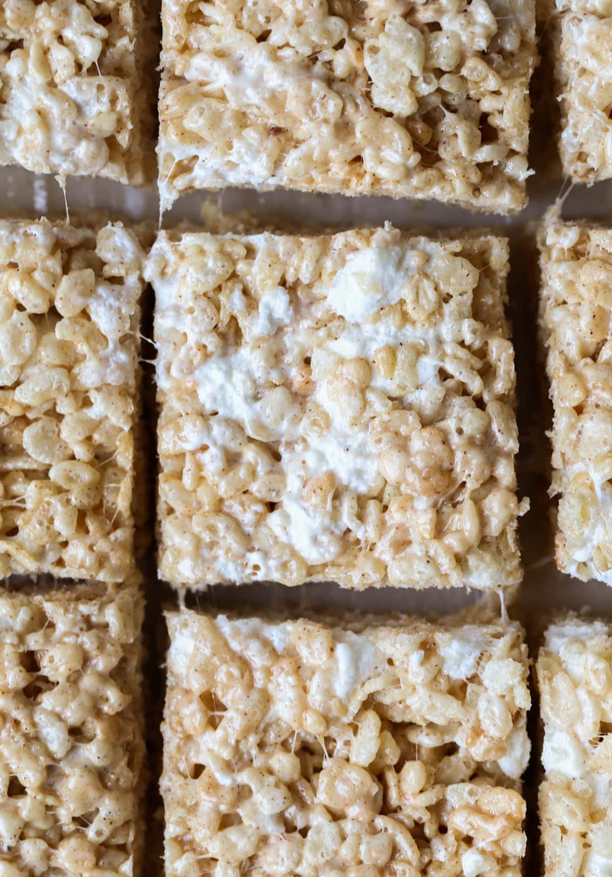 Brown Butter Pumpkin Spice Krispie Treats are the ultimate fall-time no bake dessert. You have a gooey, marshmallow-packed cereal bar made with super flavorful with browned butter and pumpkin spice! Pumpkin Spice Rice Krispie Treats cut into squares on a cutting gboard from above.