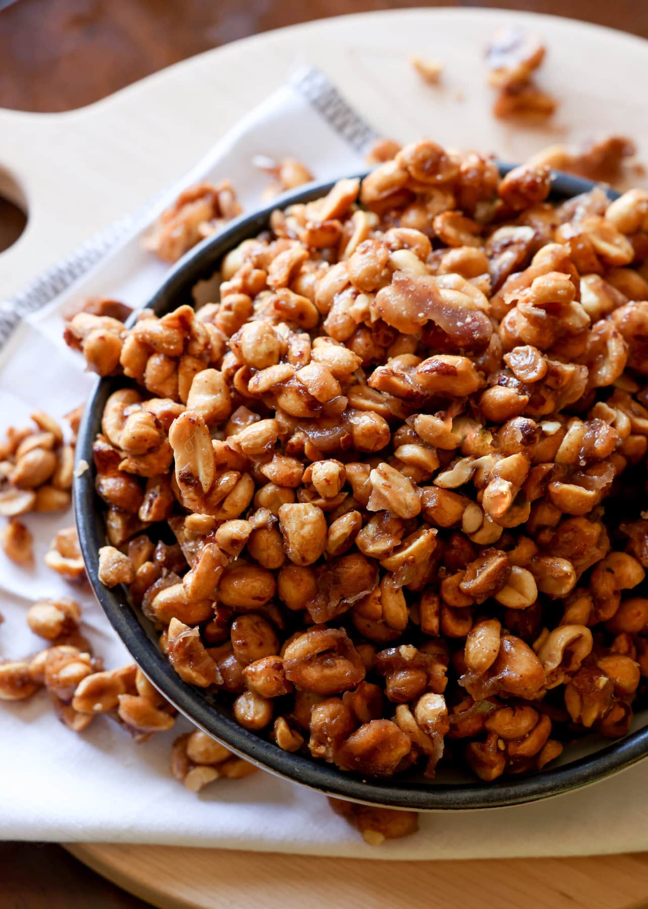Crunchy, buttery, sweet, and salty roasted Butter Toffee Peanuts are easy to make and a great snack to enjoy or gift! Candied Peanuts in a bowl