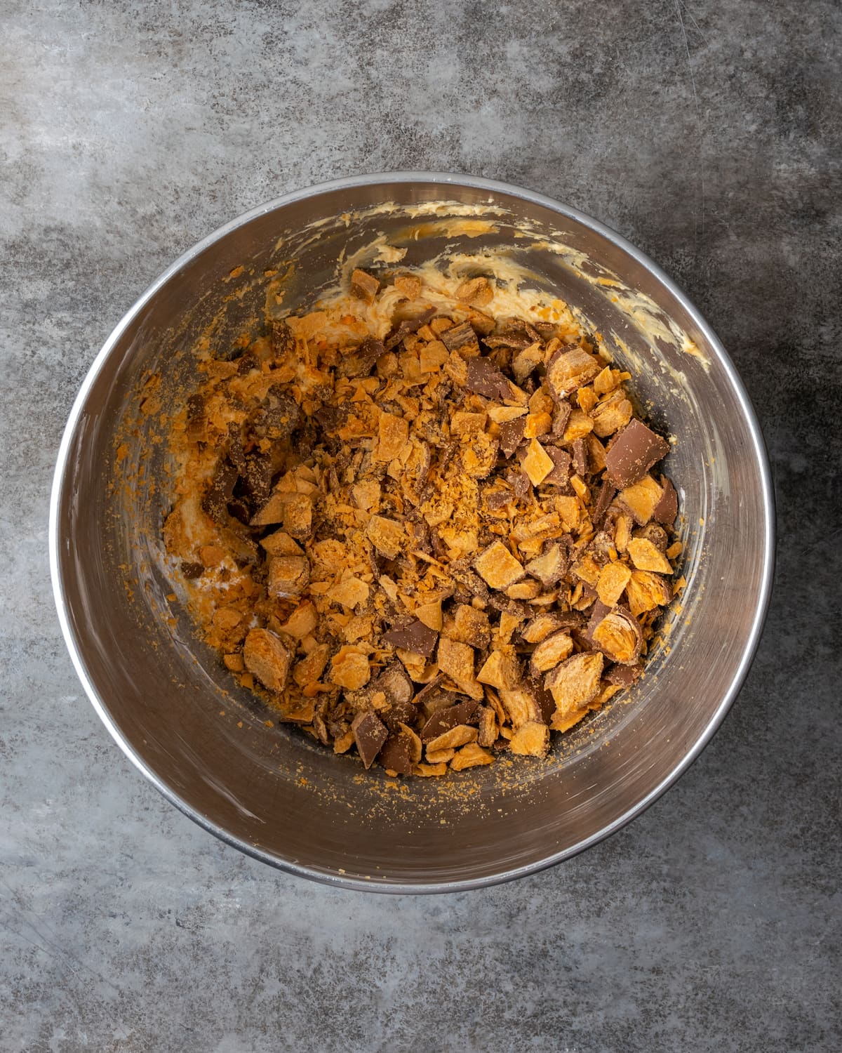 Creamy Butterfinger Pie is an easy dessert recipe that's loaded with Butterfinger candy bars! Treat yourself to this tasty peanut butter pie! Chopped Butterfinger candy is added into a bowl of peanut butter mixture for the pie filling.