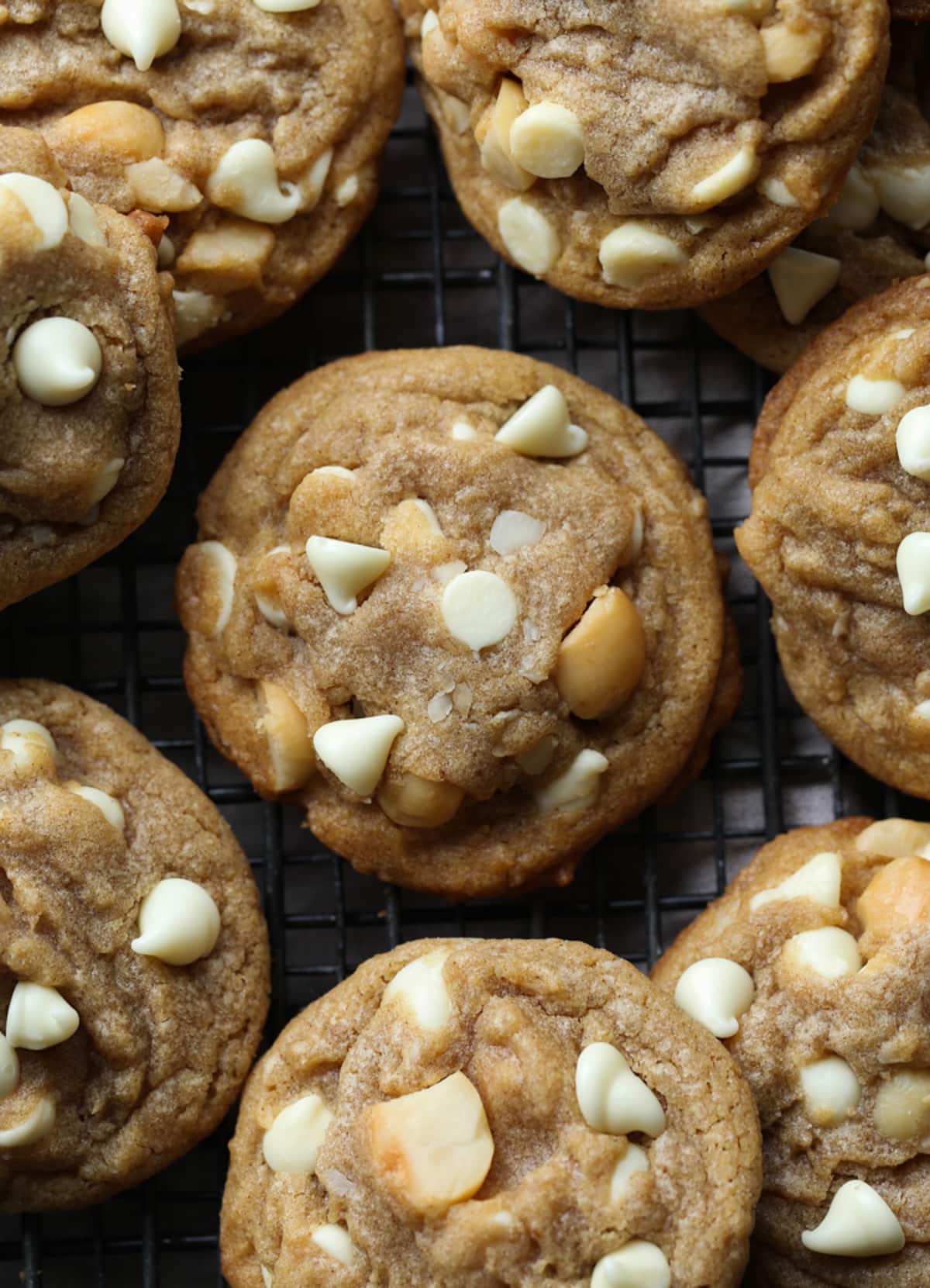 These white chocolate macadamia nut cookies are a classic. They have buttery, crisp edges with chewy centers loaded with creamy white chocolate and salty macadamia nuts. White chocolate macadamia nut cookies on a wire rack