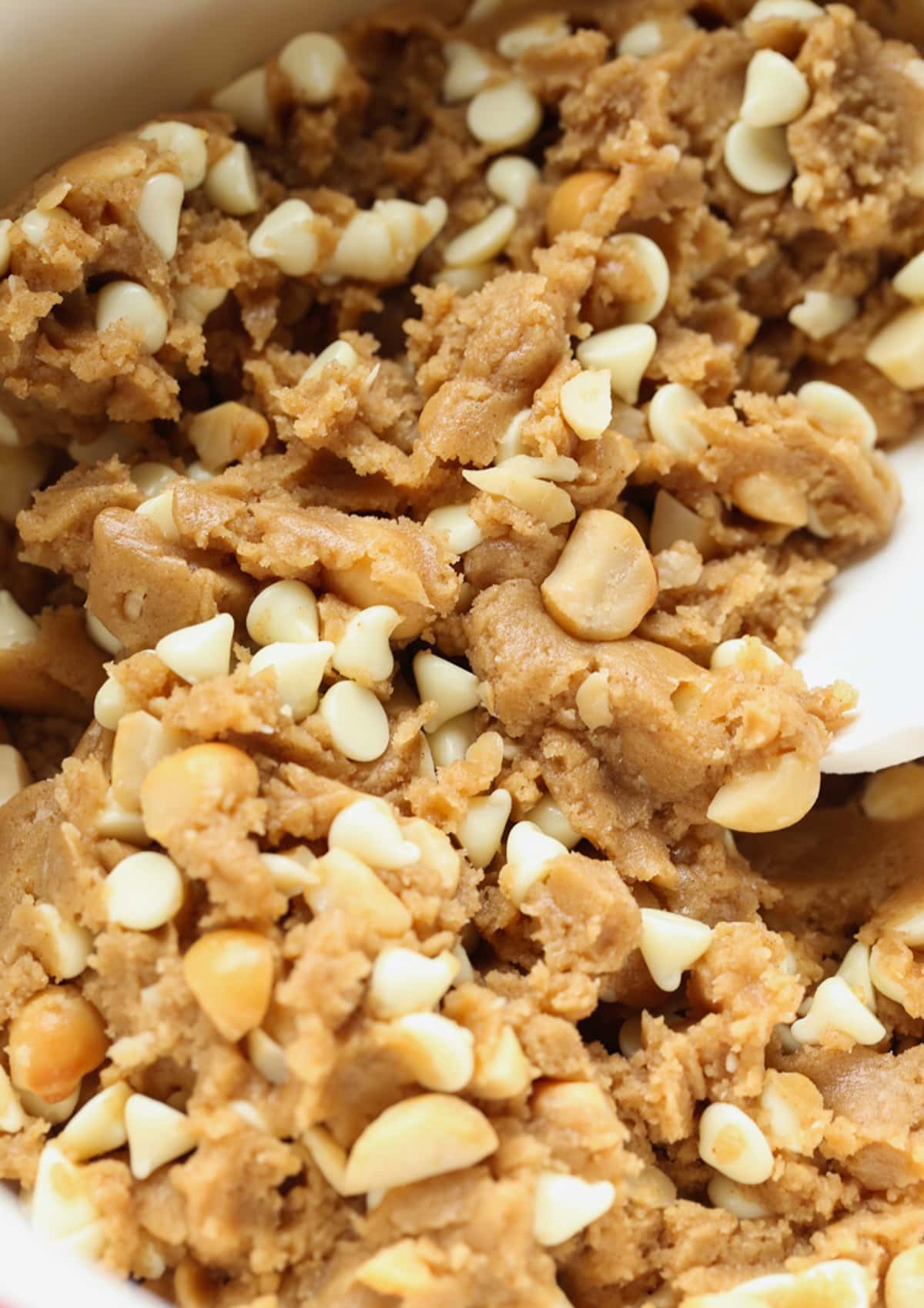These white chocolate macadamia nut cookies are a classic. They have buttery, crisp edges with chewy centers loaded with creamy white chocolate and salty macadamia nuts. White Chocolate Macadamia Nut Cookie dough in a silver stand mixer mixing bowl
