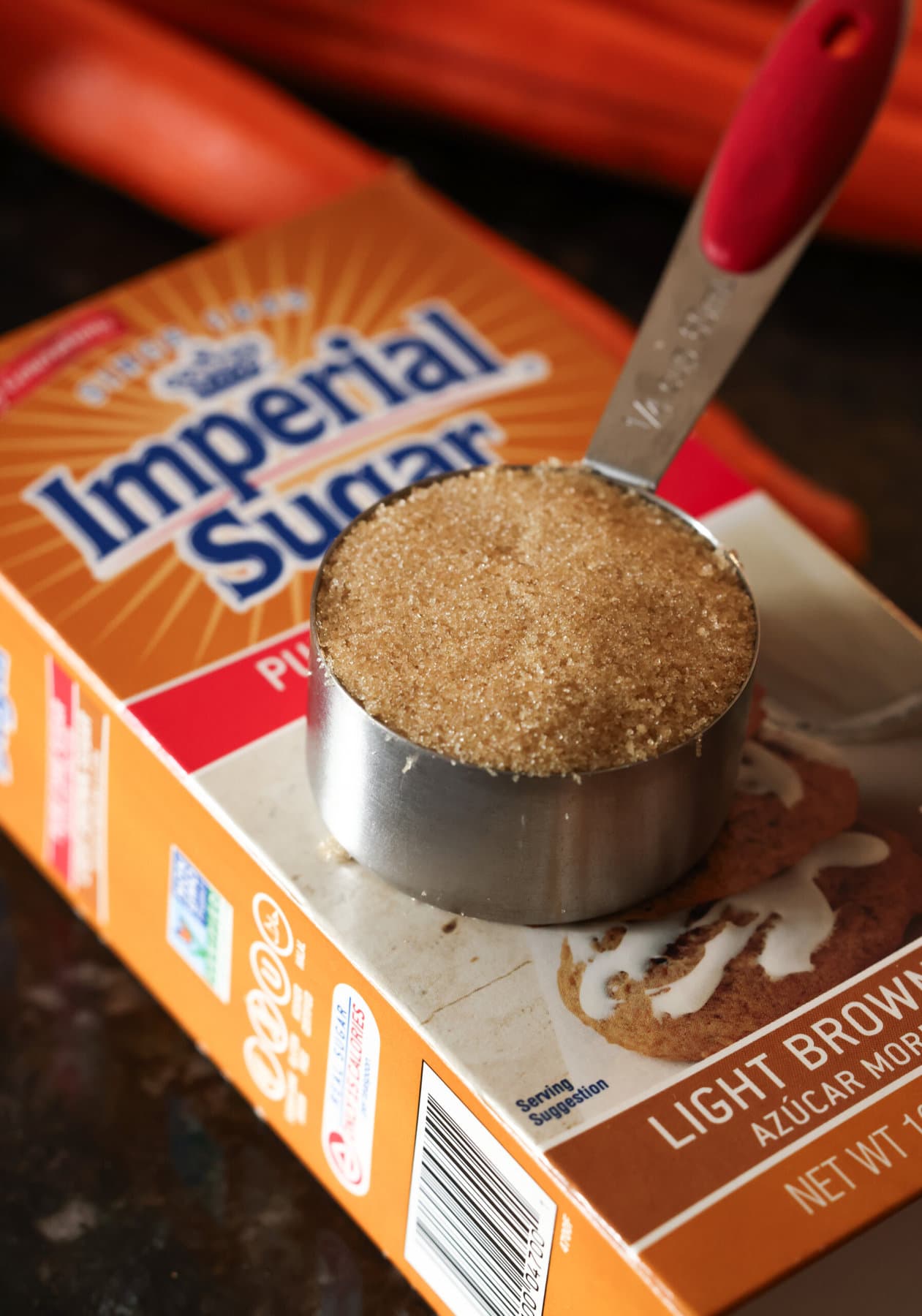 1/4 cup of brown sugar in a measuring cup on top of a box of Imperial SUgar