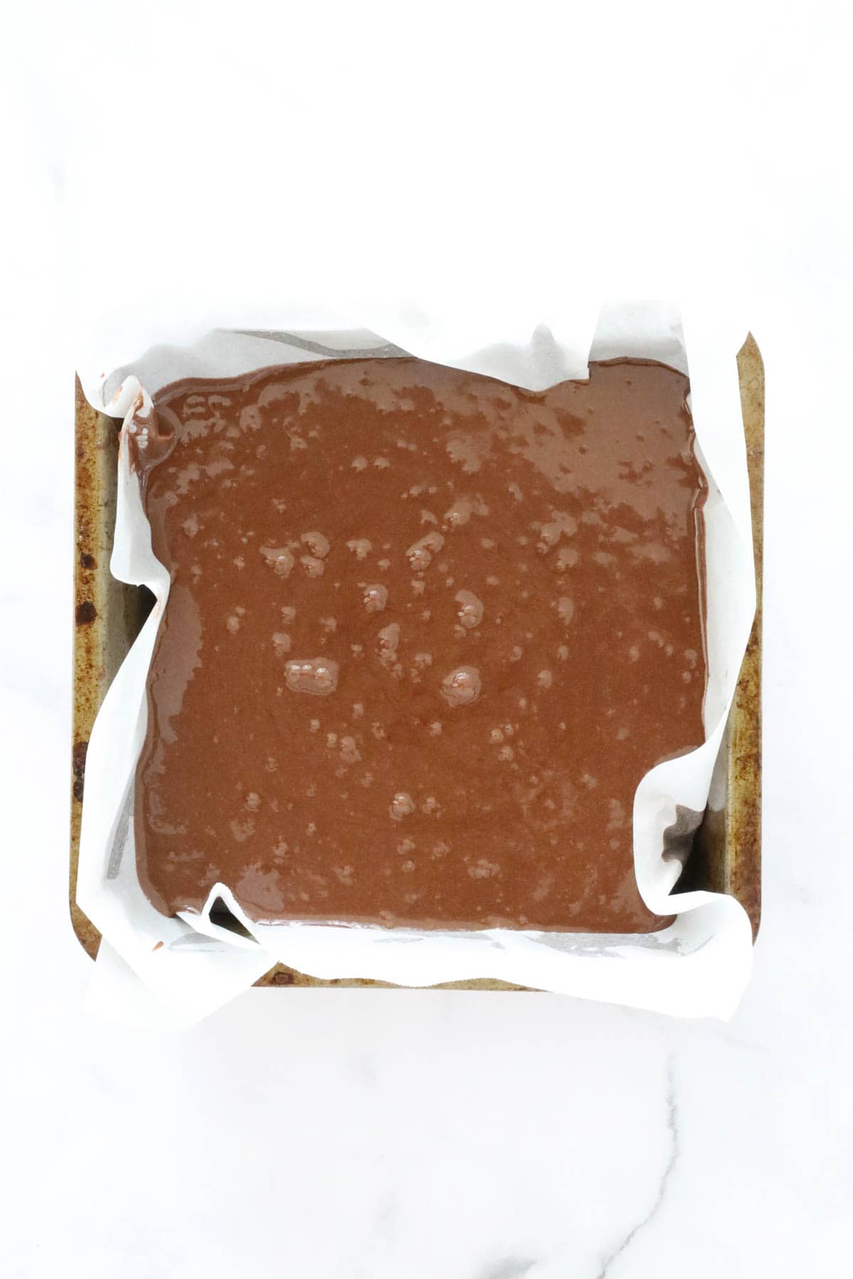Brownie batter in a tin.