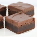 A slice of moist brownie topped with frosting.