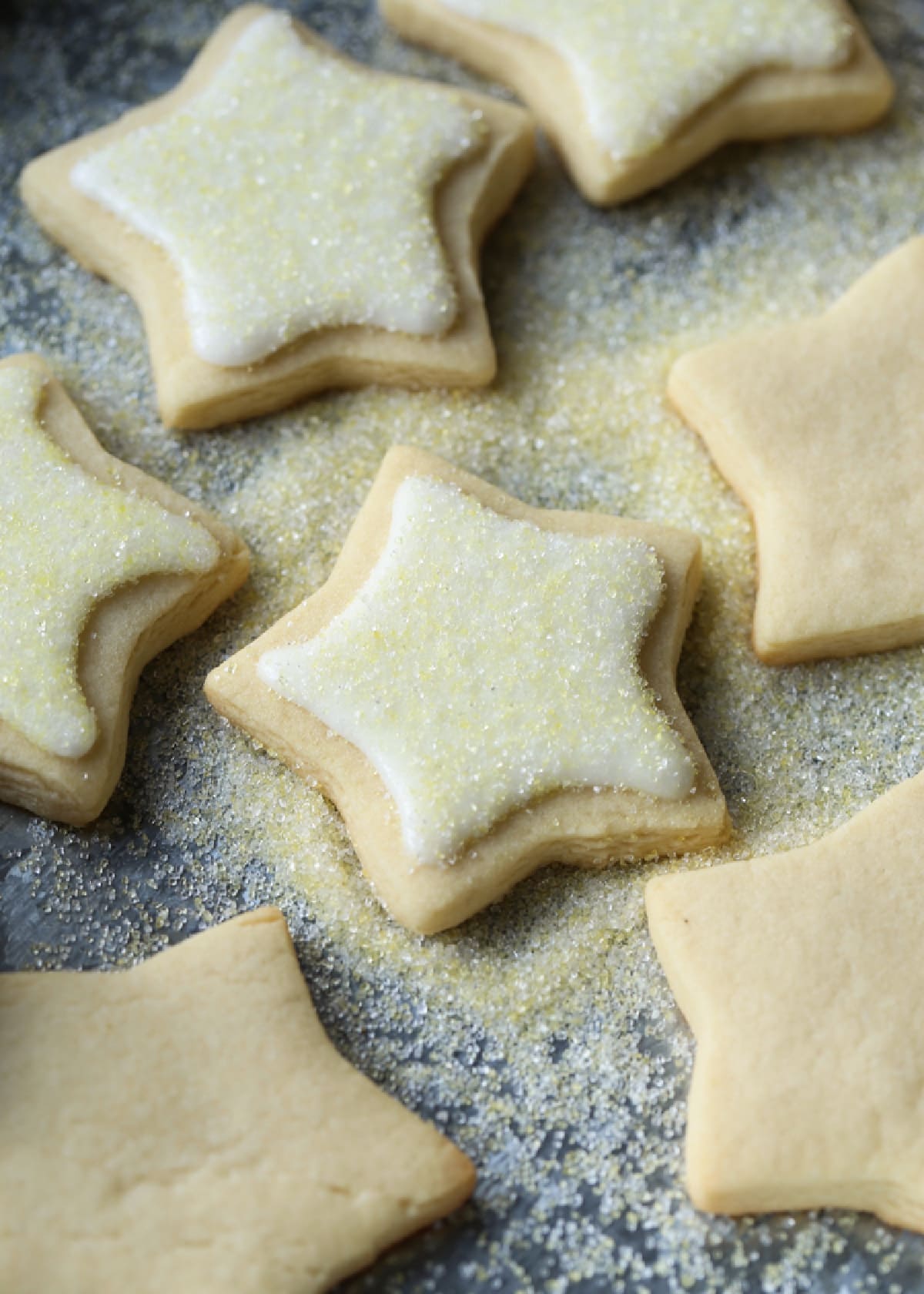 Cut Out Sugar Cookies cut into star shapes iced and dusted with yellow decorating sugar.