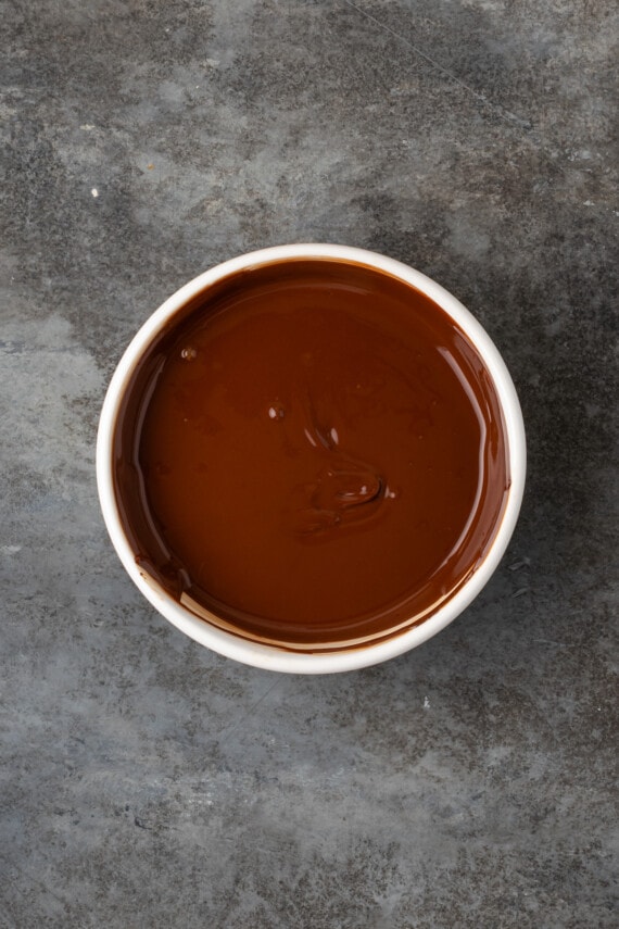 Melted chocolate in a white bowl.