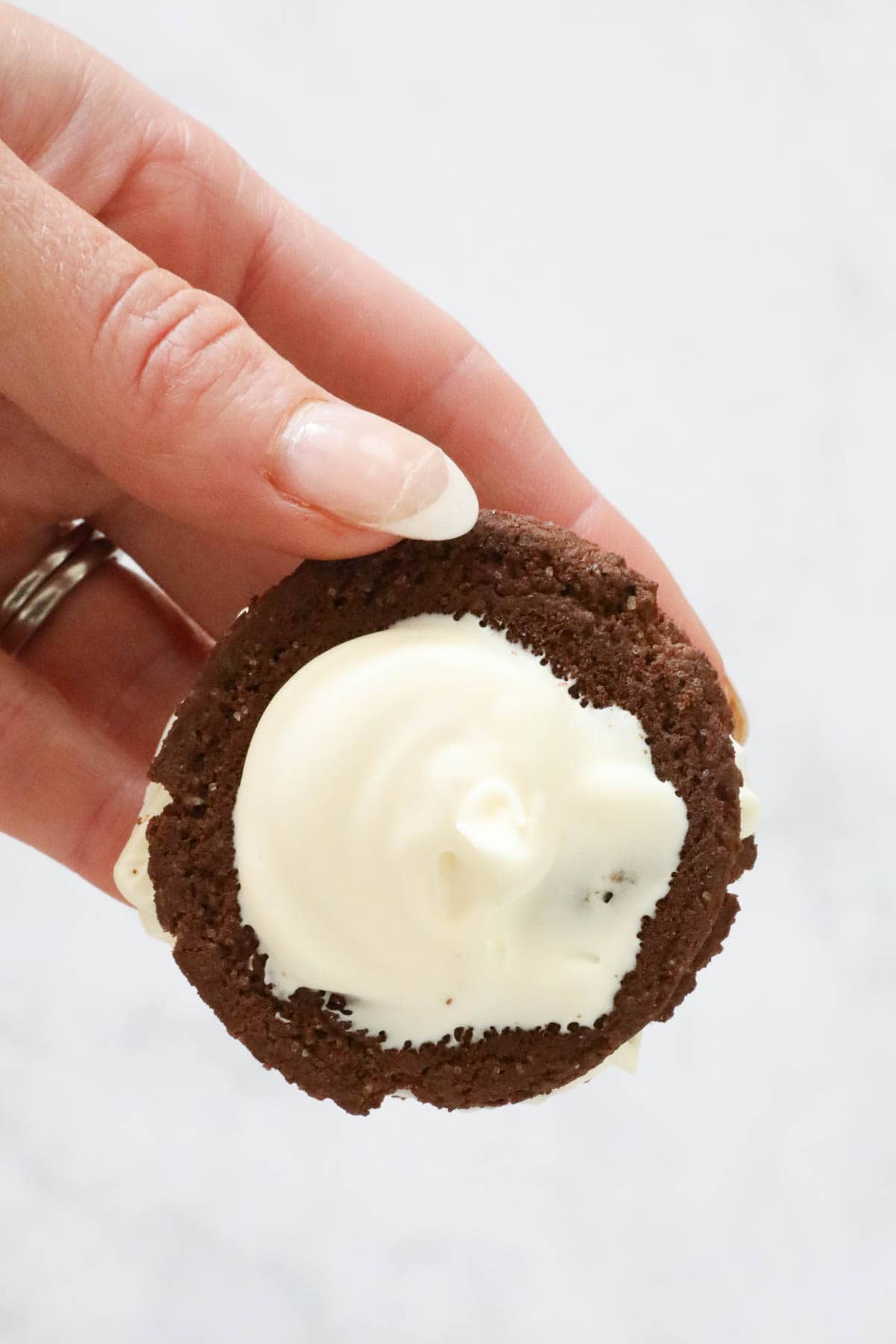 Whipped cream on a choc ripple biscuit.