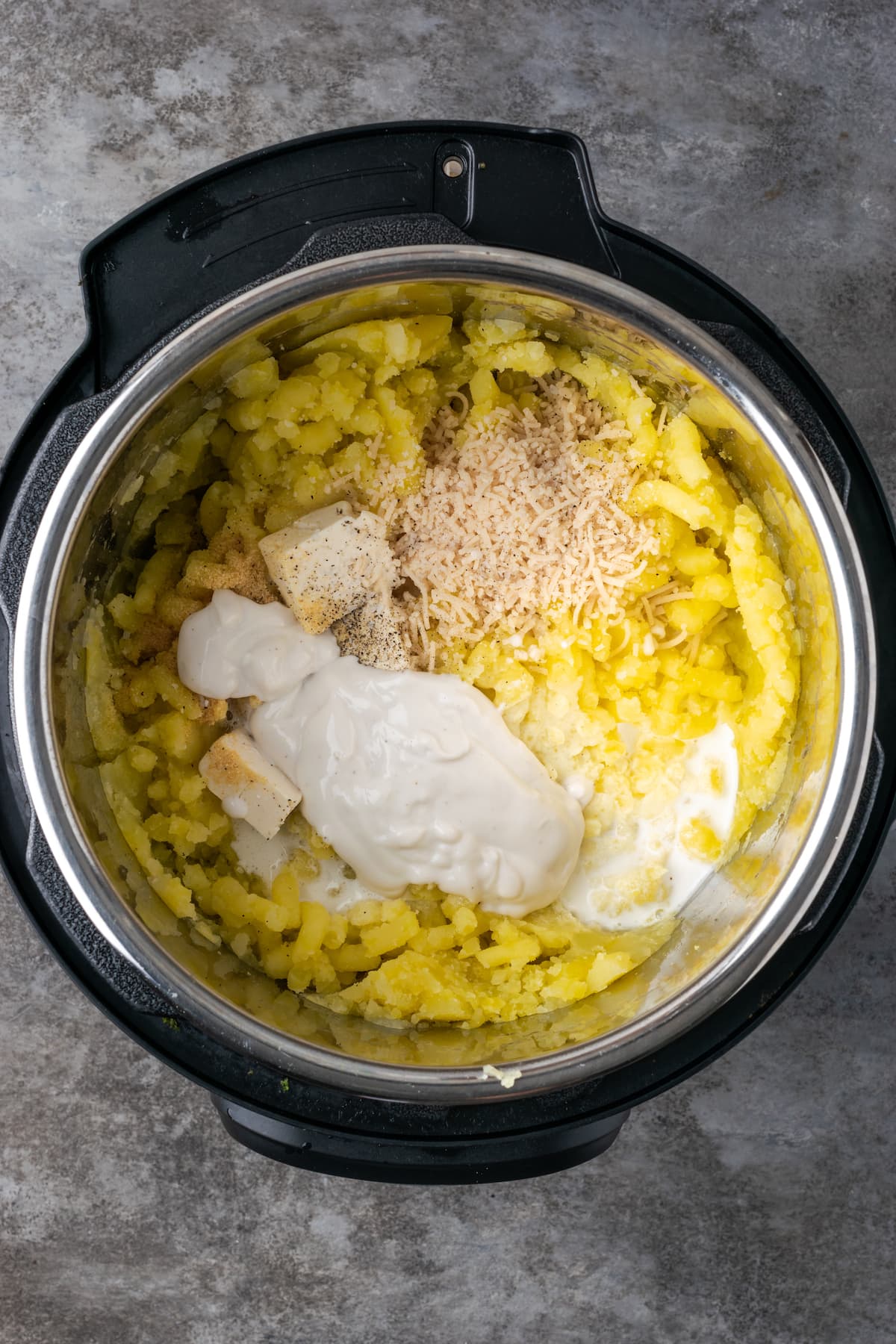 Buttery, fluffy Instant Pot Mashed Potatoes are a flavorful and easy side dish. Enjoy creamy homemade mashed potatoes, ready in half the time! Seasonings, sour cream, and butter added to mashed potatoes inside the Instant Pot.