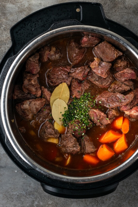 Beef stew ingredients combined inside the instant pot.
