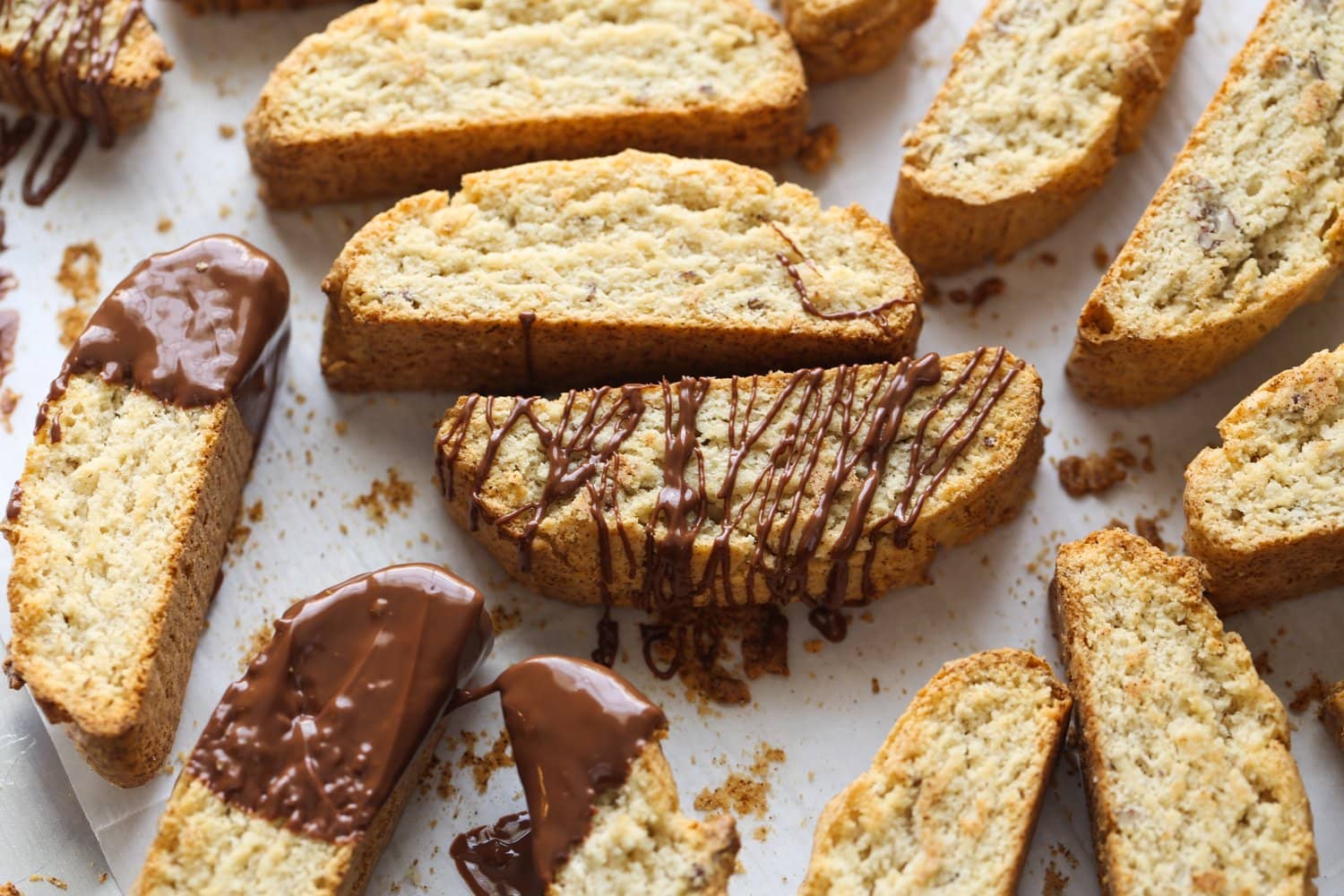 This classic Italian Biscotti recipe is super easy to make and totally customizable! Add sliced almonds or dip them in chocolate! Almond cookies drizzled with chocolate.