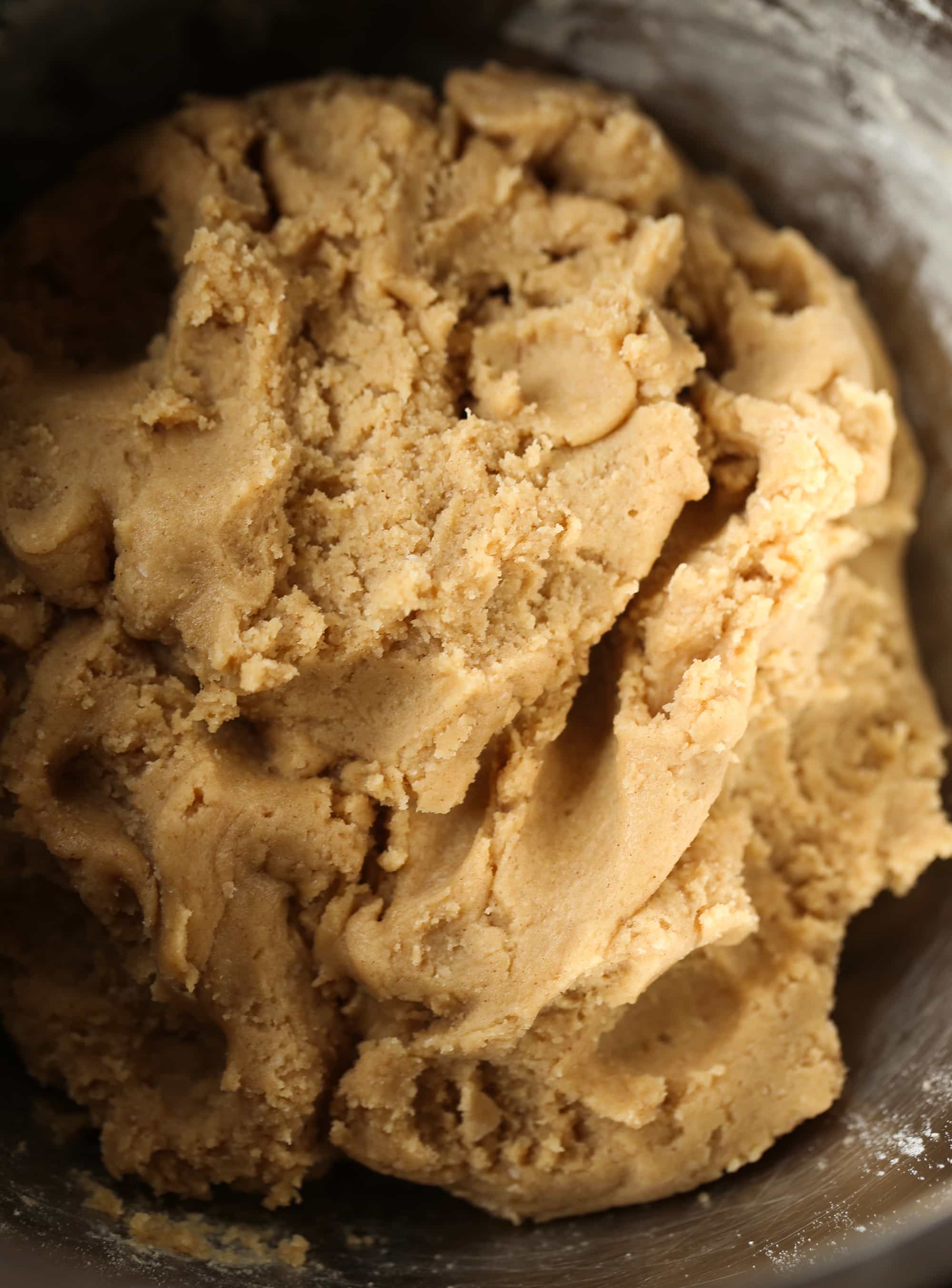 Buttery, chewy cookie bars that taste just like a churro! Brown butter cookie dough in a metal mixing bowl.