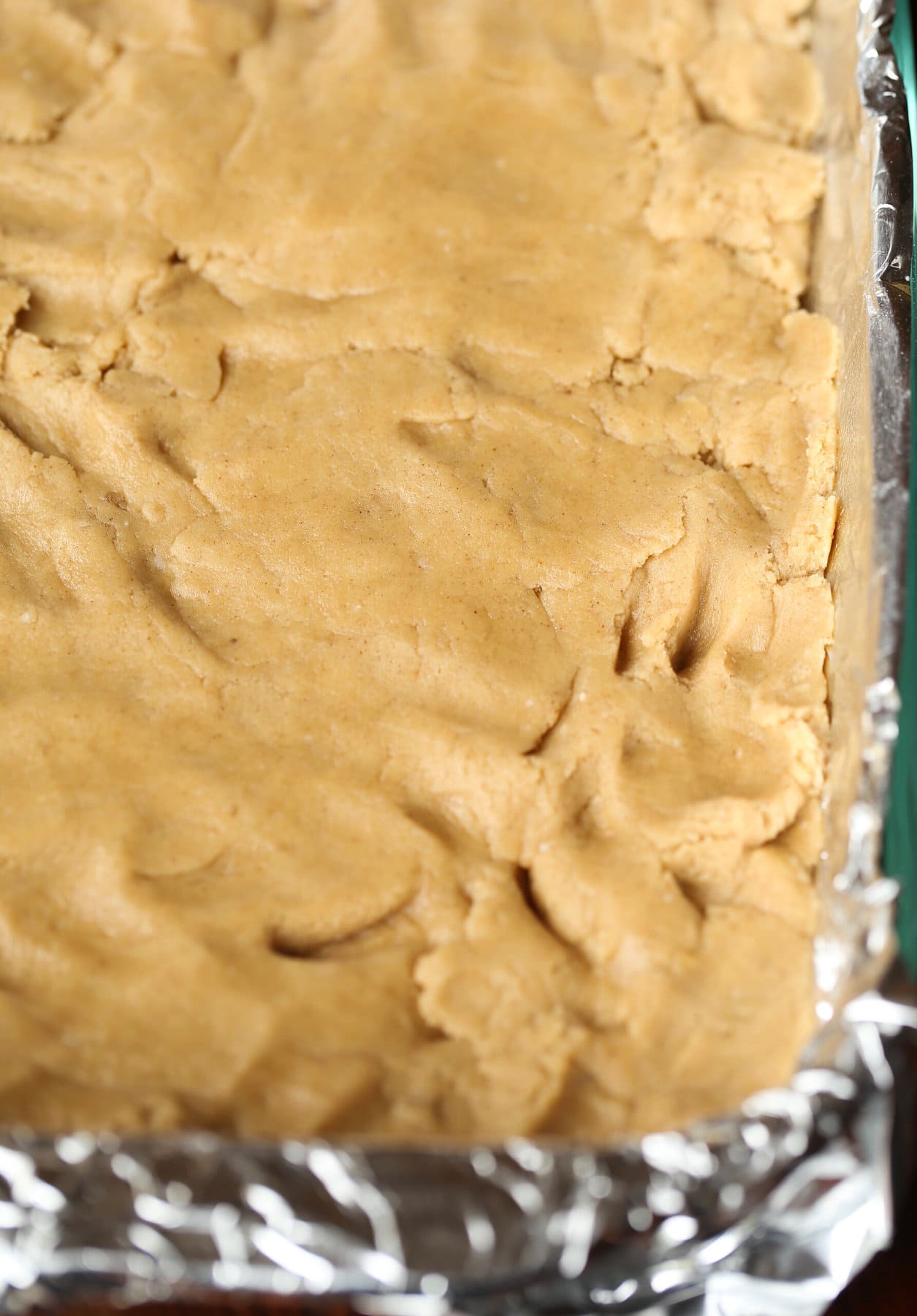 Buttery, chewy cookie bars that taste just like a churro! Cookie dough pressed into a 9x13 pan.